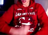 a handsome boy with a red swet masturbates  and eats his cum
