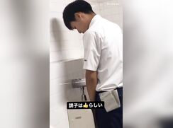 A male student is pissing in the toilet 2