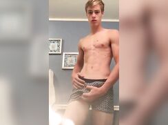 Blond boy in underwear slowly strips