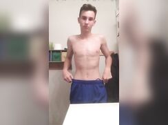 Boy in blue shorts slowly strips hiding his cock