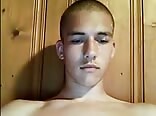 Buzz cute twink strokes his cock while watching some gay porn