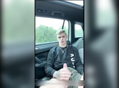 Cute boy wanks in his car