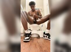 Hung black muscle boy wanks and cums on the toilet