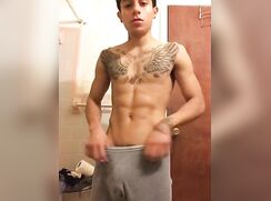 Latino with eagle tattoo showing off