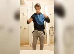 Stunningly beautiful twink jerks off like in public restroom. Great cum shot.
