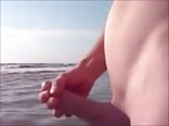 Twink jerking and cumming in the sea