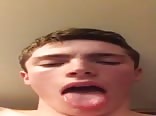 Young boy shows his tongue 