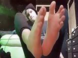 Young boy twink showing off his barefeet in trainers.